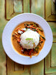 Thai red curry with mango chutney and jasmine rice plated beautifully