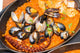 Arroz con Pulpo y Almejas: El Tesoro Marinero del Verano | Puerto de Oriente